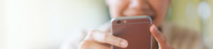 A man texting on his iPhone, focused on the screen while typing a message