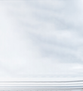 A serene view of soft, fluffy clouds spread across the sky